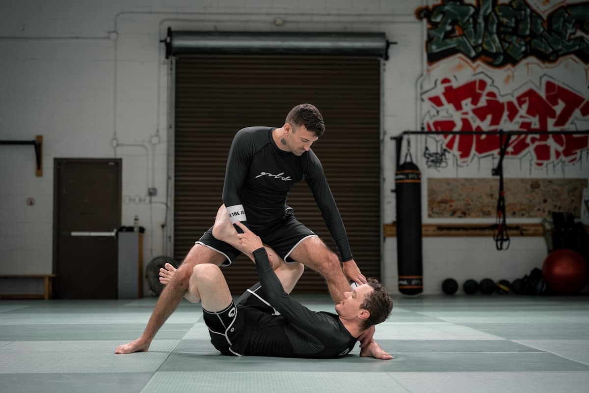Two athletes drilling a no-gi guard pass